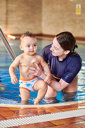 Water Babies teacher and baby in a pool having a lesson