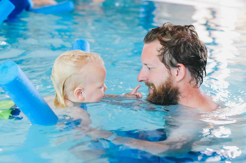 Dad and toddler enjoying a winter swimming lesson
